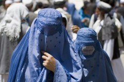 BEST QUALITY AVAILABLE  Burqa-clad Afghan women walk in a market in the old part of Kabul